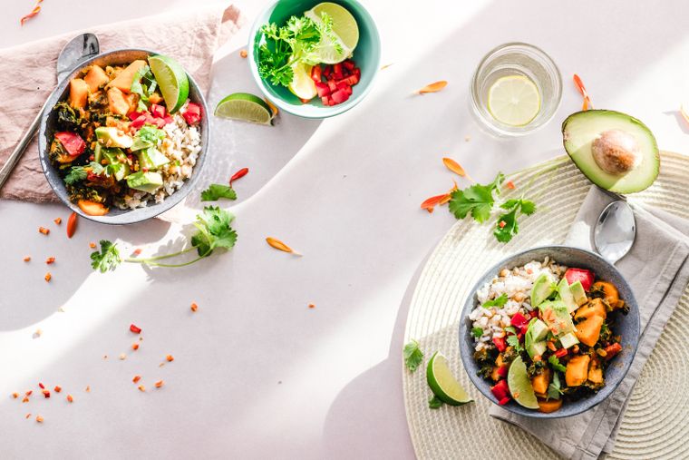 Sliced fresh avocado on a cutting board — rich in monounsaturated fats that fuel metabolism